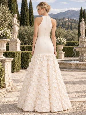 Back view of an ivory mother of the bride dress featuring a sleeveless high-back fitted bodice with a center back zipper and a floor-length mermaid skirt covered with dimensional 3D floral petal appliqués.
