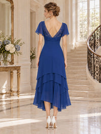 Floral lace chiffon mother of the bride dress with deep V-back, flutter sleeves and layered midi skirt, back view.