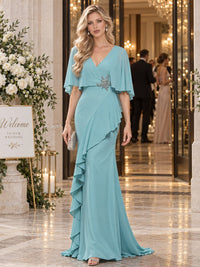Chiffon sheath mother of the bride evening dress with V-neckline, cape sleeves, embellished waist applique and cascading side ruffle, front view.