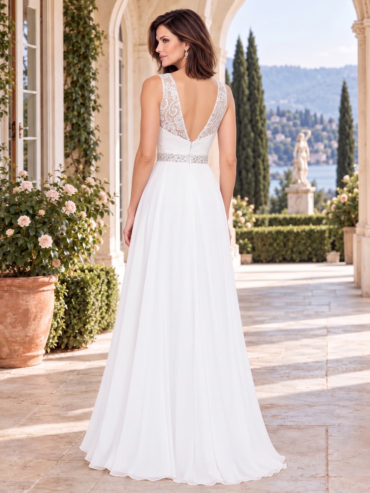 Back view of a lace chiffon A-line mother of the bride dress with deep V lace back, embellished waist and floor-length chiffon skirt.