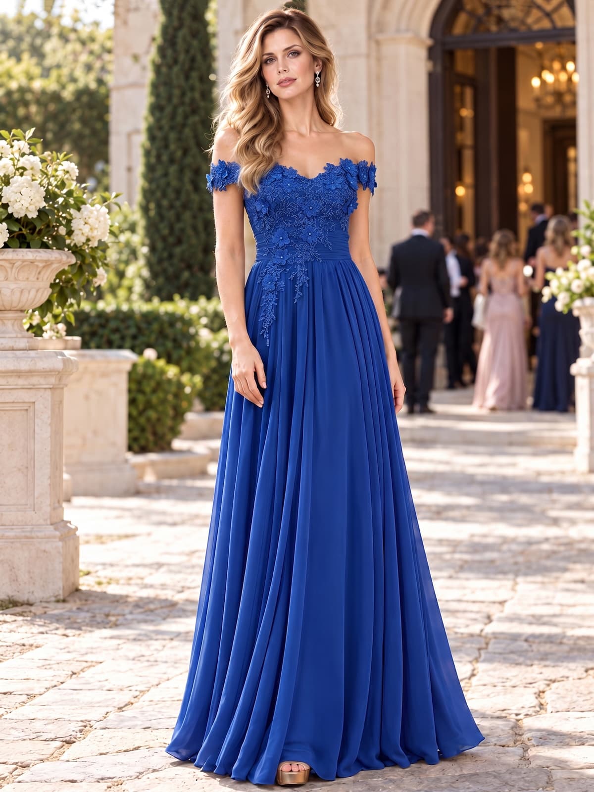 Front view of a chiffon A-line mother of the bride dress with off-the-shoulder neckline, lace bodice, 3D floral appliqués and floor-length skirt.