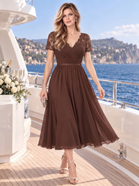 Front view of a lace chiffon A-line mother of the bride dress with V-neckline, short lace sleeves, ruched bodice and midi skirt.