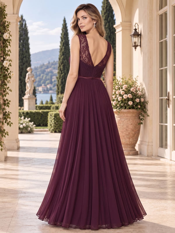 Back view of a lace chiffon A-line mother of the bride dress with deep V-back, lace shoulder panels, defined waistband and floor-length skirt.
