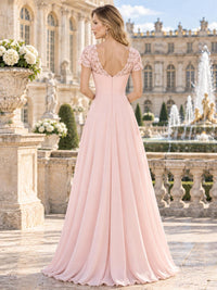 Back view of a lace chiffon A-line mother of the bride dress with deep V-back, floral lace shoulders and center-back zipper.