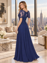 Back view of a beaded lace chiffon A-line mother of the bride dress with sheer floral lace back, short sleeves and center-back zipper.