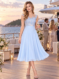 Front view of a floral lace chiffon A-line mother of the bride dress with illusion neckline and tea-length skirt.