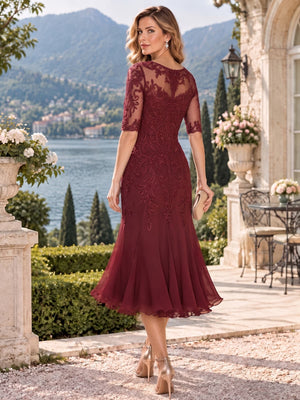 Back view of a floral lace chiffon sheath mother of the bride dress with sheer lace back, elbow sleeves and center-back zipper.