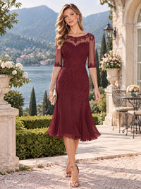 Front view of a floral lace chiffon sheath mother of the bride dress with illusion bateau neckline, elbow sleeves and tea-length flared hem.