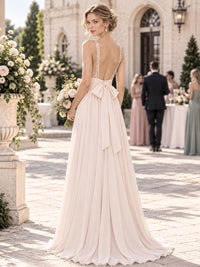 Back view of a sequin floral chiffon A-line mother of the bride dress with deep V-back, bow sash and floor-length skirt.