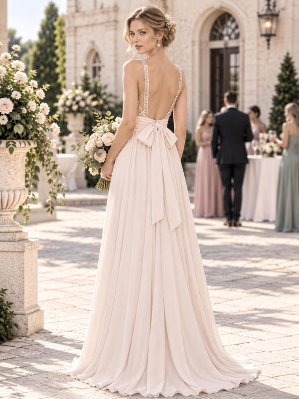 Back view of a sequin floral chiffon A-line mother of the bride dress with deep V-back, bow sash and floor-length skirt.