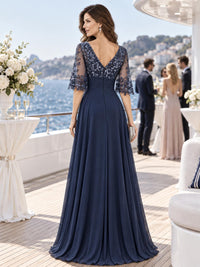 Back view of a floral lace chiffon A-line mother of the bride dress with deep V lace back and center-back zipper.