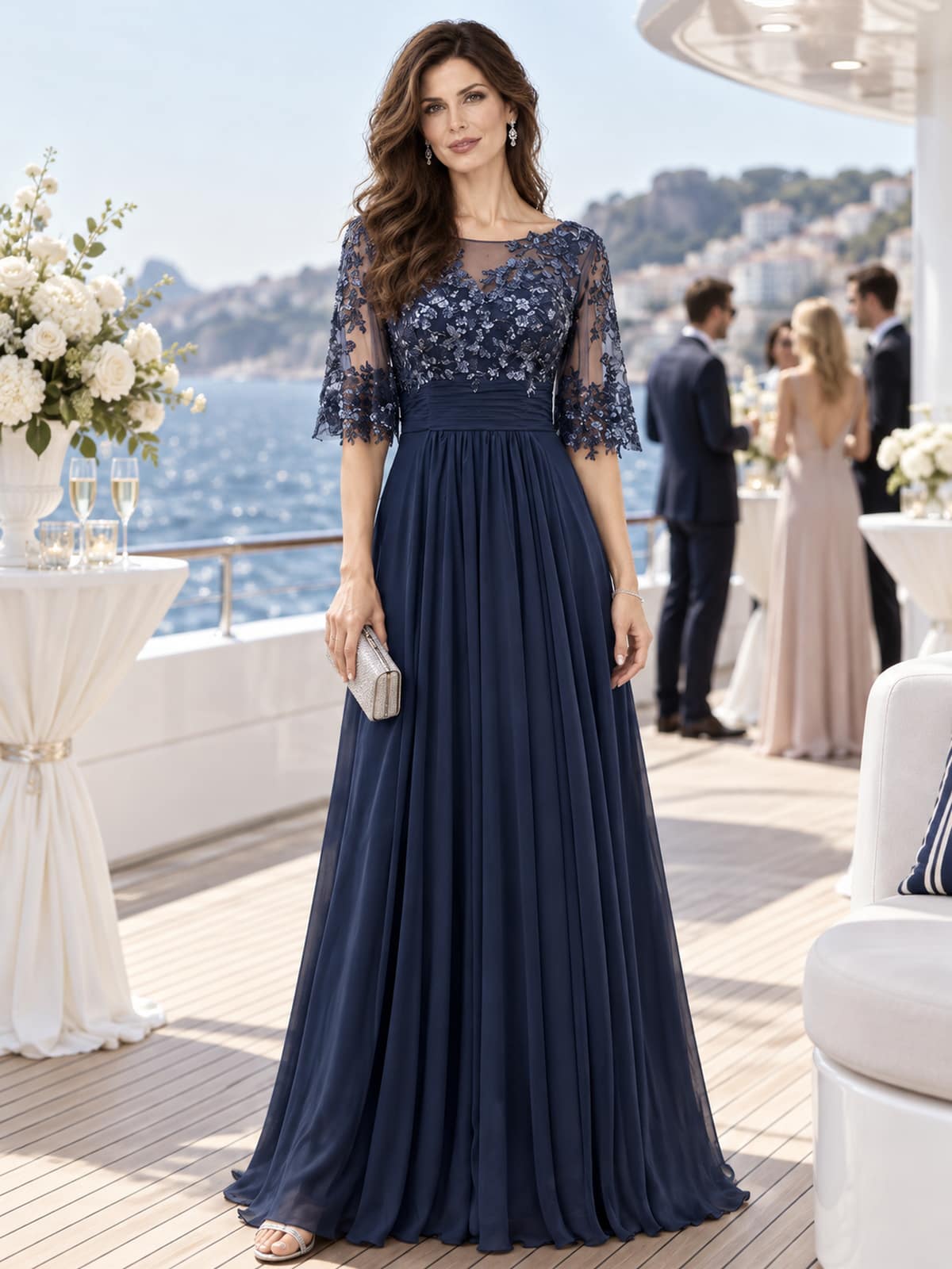 Front view of a floral lace chiffon A-line mother of the bride dress with illusion neckline, lace sleeves and ruched waist.