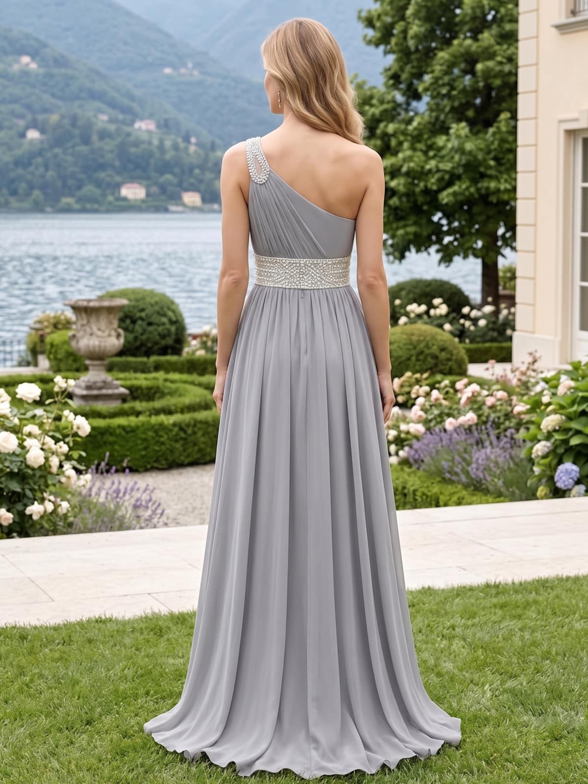 Back view of a chiffon mother of the bride dress with asymmetrical one-shoulder design, beaded waistband and center-back zipper.