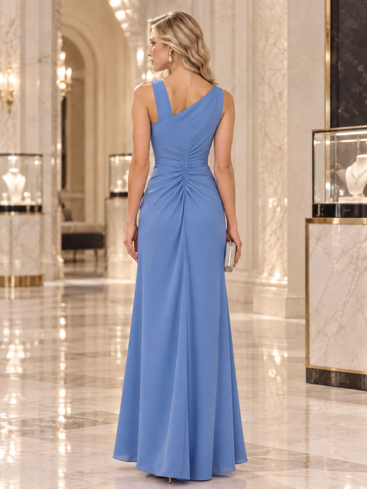 Back view of a satin one-shoulder mother of the bride dress with ruched waist and streamlined floor-length skirt.